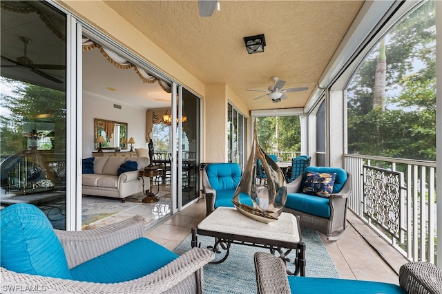 sunroom / solarium with ceiling fan and a healthy amount of sunlight