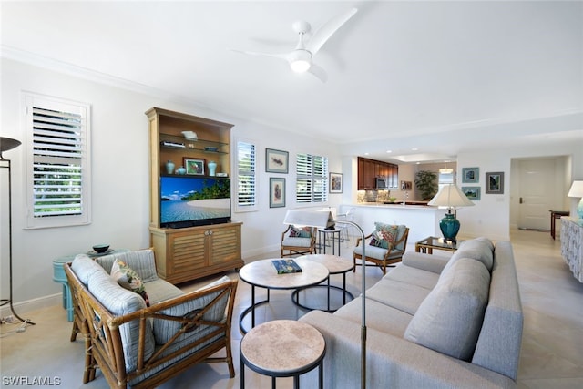 living room featuring light tile floors, crown molding, and ceiling fan