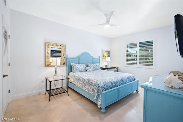 tiled bedroom with a closet and ceiling fan