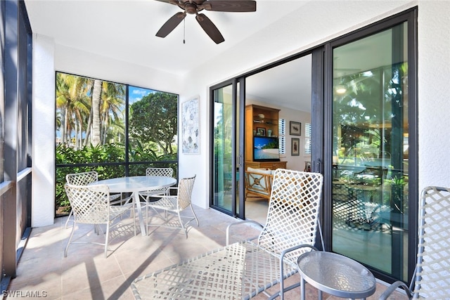 sunroom / solarium featuring ceiling fan