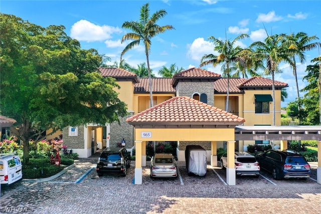 mediterranean / spanish-style home featuring a carport