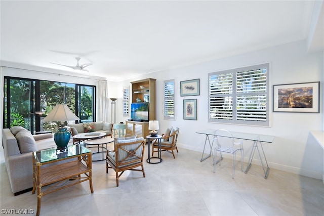 tiled living room featuring ceiling fan and crown molding