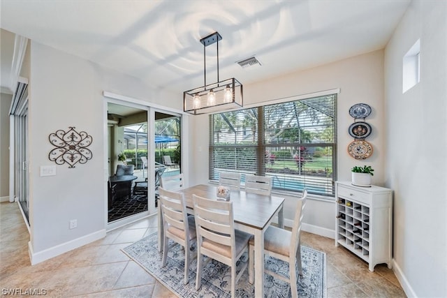 dining space with a notable chandelier and light tile flooring