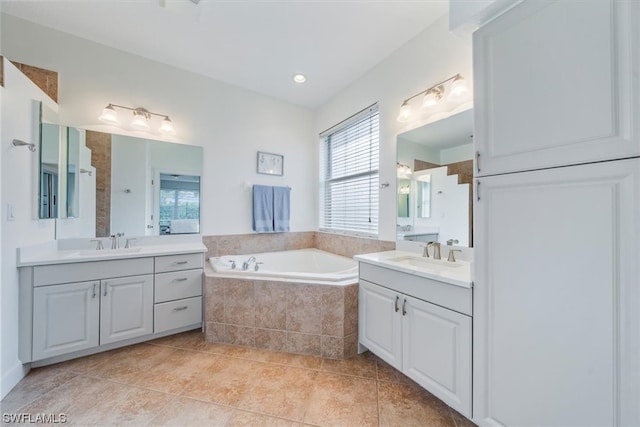 bathroom featuring double vanity, a relaxing tiled bath, and tile flooring