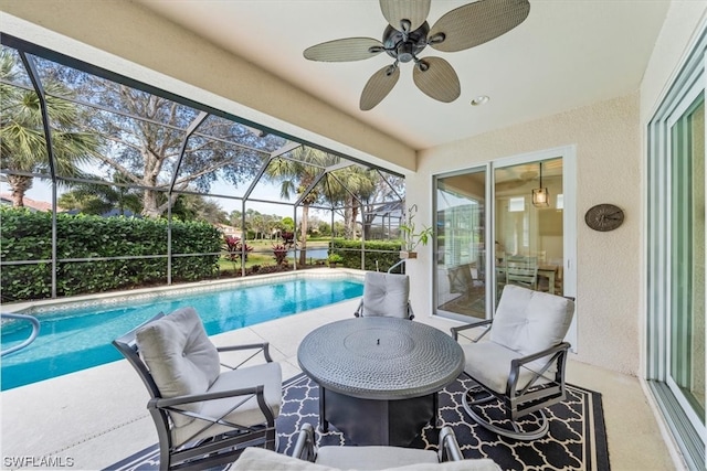 view of pool featuring ceiling fan, a patio, and a lanai