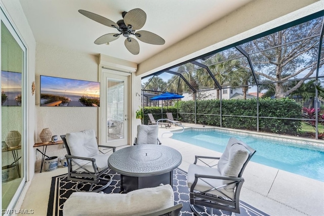 view of pool featuring a lanai, ceiling fan, and a patio