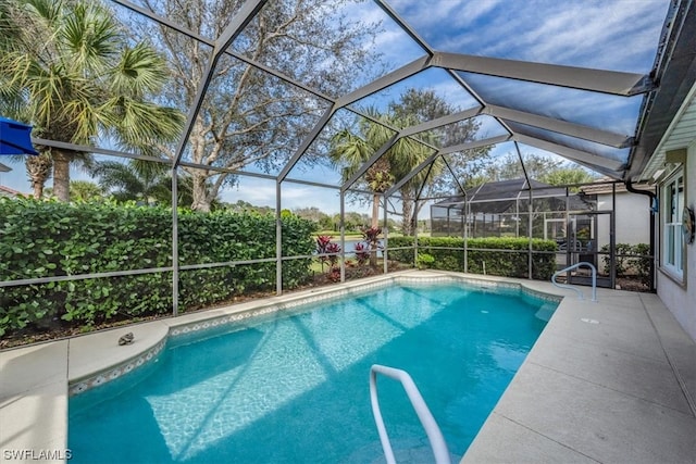 view of pool featuring a lanai and a patio