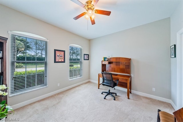 carpeted office space featuring ceiling fan