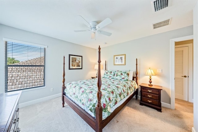 bedroom with light colored carpet and ceiling fan