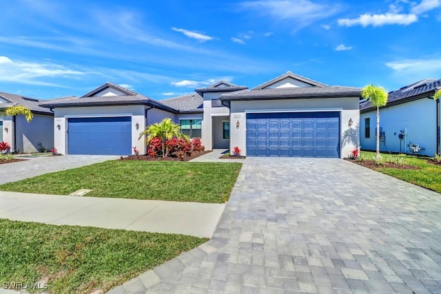 ranch-style home featuring a front yard and a garage