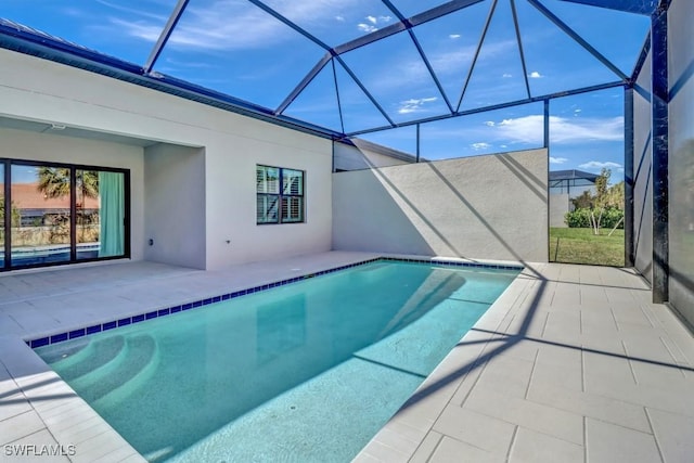 view of pool featuring glass enclosure and a patio