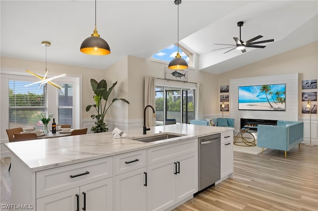 kitchen with white cabinetry, stainless steel dishwasher, ceiling fan with notable chandelier, and sink