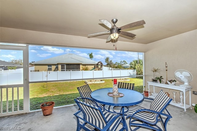 sunroom / solarium featuring ceiling fan