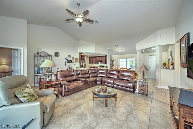 living room with ceiling fan, light tile patterned floors, and lofted ceiling