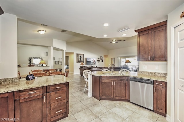 kitchen with sink, light stone counters, stainless steel dishwasher, kitchen peninsula, and lofted ceiling