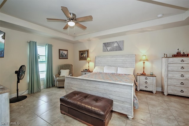 bedroom featuring a tray ceiling, ceiling fan, and light tile patterned flooring