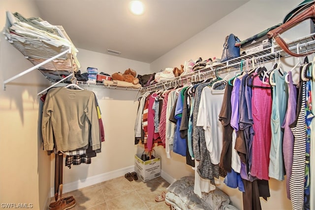 spacious closet with light tile patterned floors