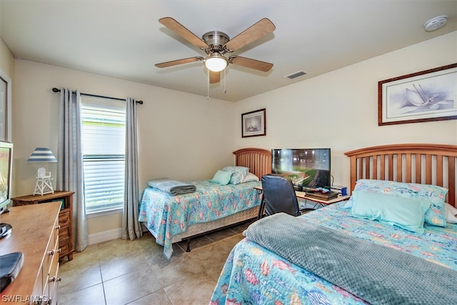 tiled bedroom with ceiling fan