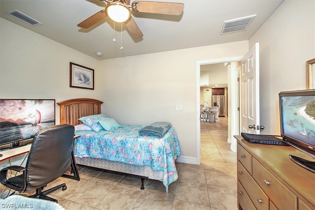 tiled bedroom featuring ceiling fan and stainless steel refrigerator with ice dispenser