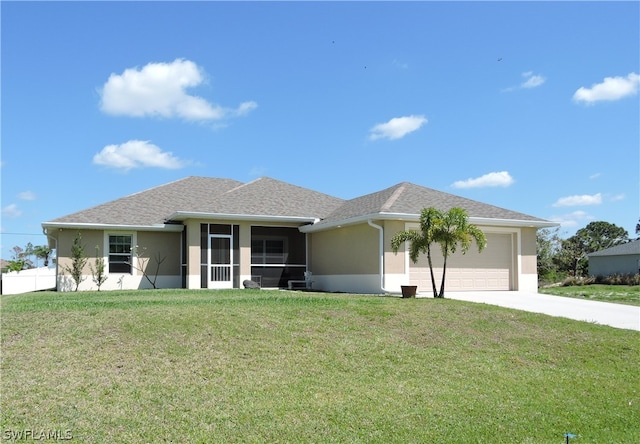 view of front of property with a front yard, a garage, and a sunroom