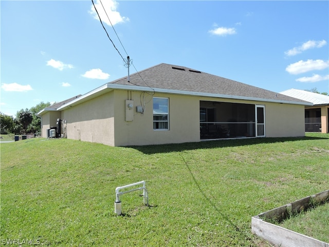 back of property featuring a yard