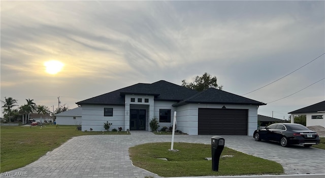 view of front facade with a lawn and a garage