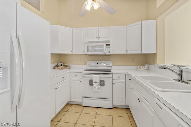 kitchen with white appliances, white cabinets, sink, and light tile floors