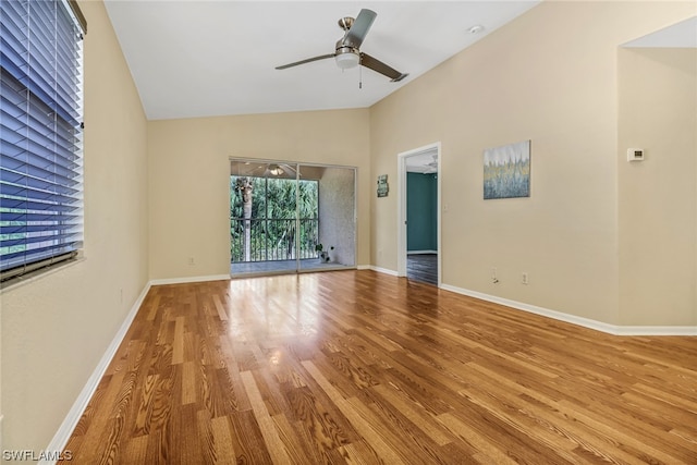 empty room featuring vaulted ceiling, ceiling fan, and light wood-type flooring