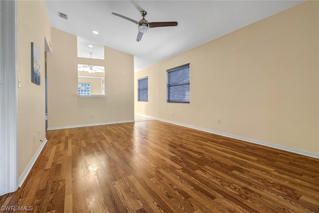 empty room featuring vaulted ceiling, wood-type flooring, and ceiling fan