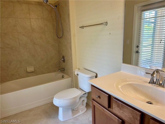 full bathroom featuring vanity, tile patterned floors, tiled shower / bath, and toilet