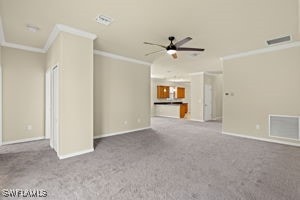 carpeted spare room with ornamental molding and ceiling fan