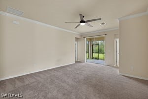 unfurnished room featuring ceiling fan, ornamental molding, and carpet