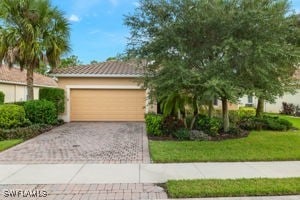 view of front facade with a garage and a front yard