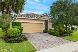 view of front of home featuring a garage and a front lawn