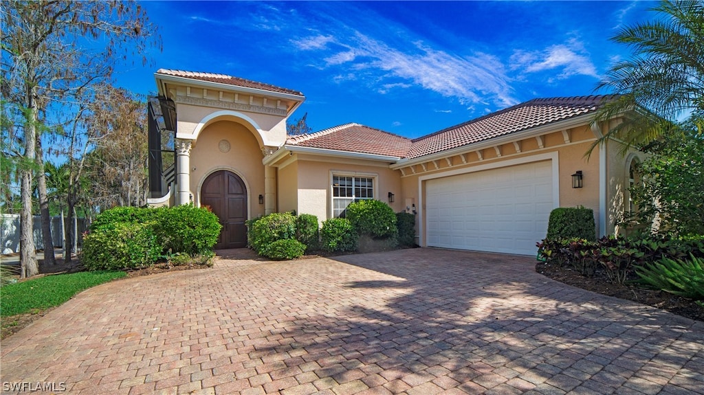 mediterranean / spanish house with a garage