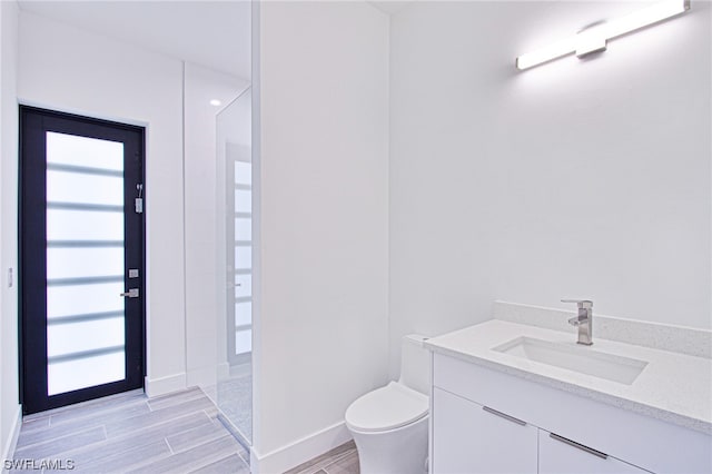 bathroom featuring toilet and vanity