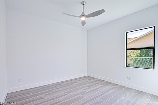 empty room with ceiling fan and light wood-type flooring