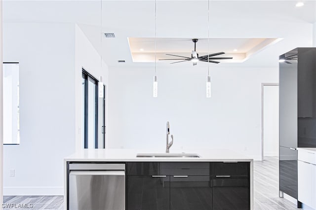 bar featuring ceiling fan, sink, light wood-type flooring, stainless steel dishwasher, and a raised ceiling