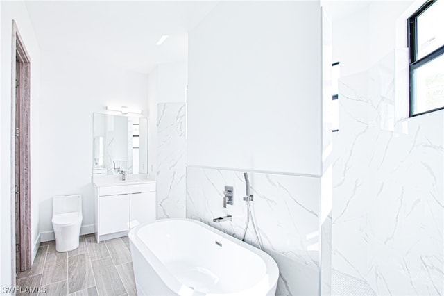 bathroom featuring tile walls, a bathing tub, tile flooring, toilet, and large vanity