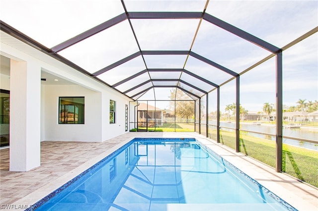 view of pool with a patio, a lanai, and a yard