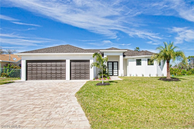 view of front of house with a front lawn and a garage