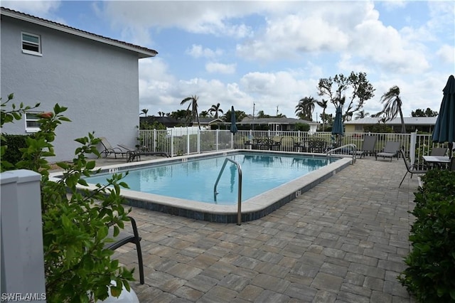 view of swimming pool featuring a patio