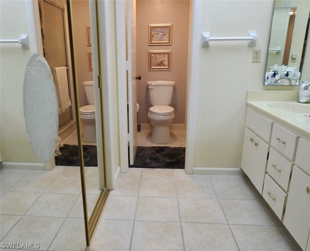 bathroom with vanity, toilet, and tile patterned flooring