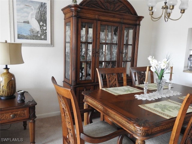 dining area featuring carpet floors and an inviting chandelier