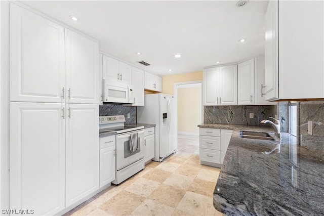 kitchen featuring light tile flooring, white appliances, white cabinetry, backsplash, and sink