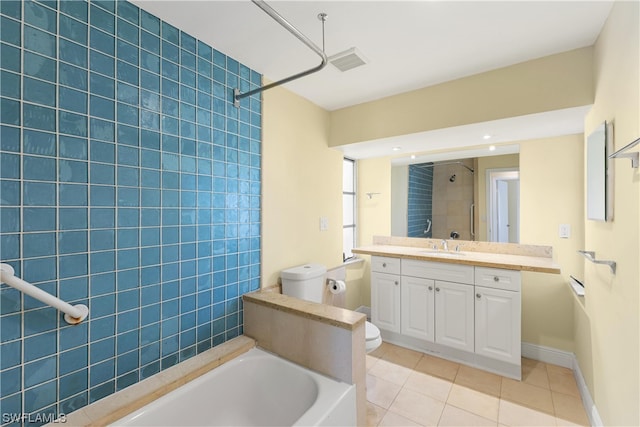 full bathroom featuring tiled shower / bath combo, tile floors, large vanity, and toilet