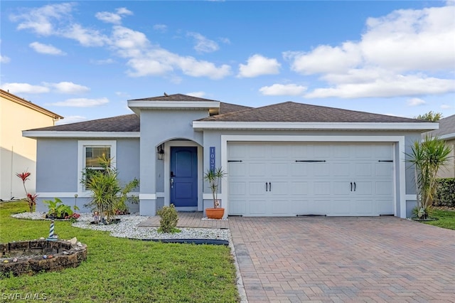 single story home featuring a garage and a front yard