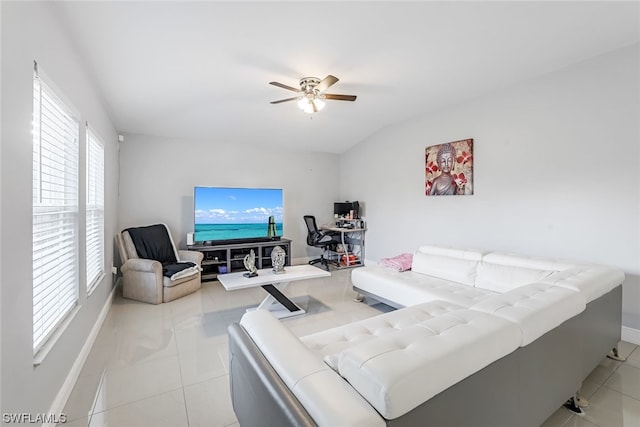 tiled living room featuring lofted ceiling, a healthy amount of sunlight, and ceiling fan