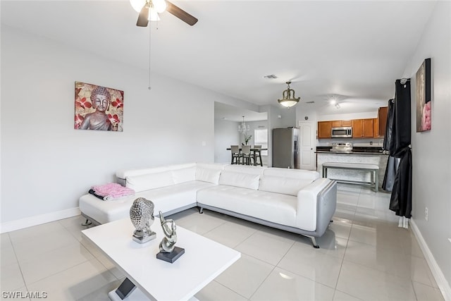 tiled living room with ceiling fan