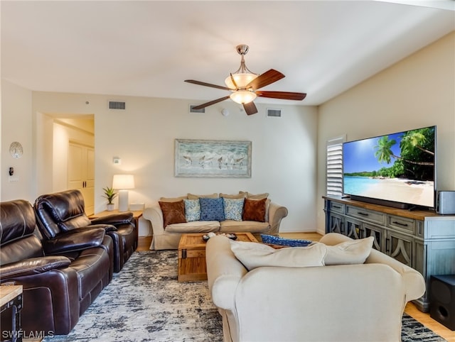 living room featuring hardwood / wood-style floors and ceiling fan